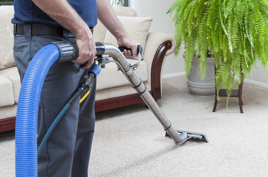 carpet cleaning guy vacuuming a carpet